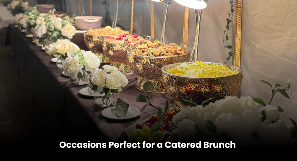Catered brunch setup with floral arrangements and food displays.